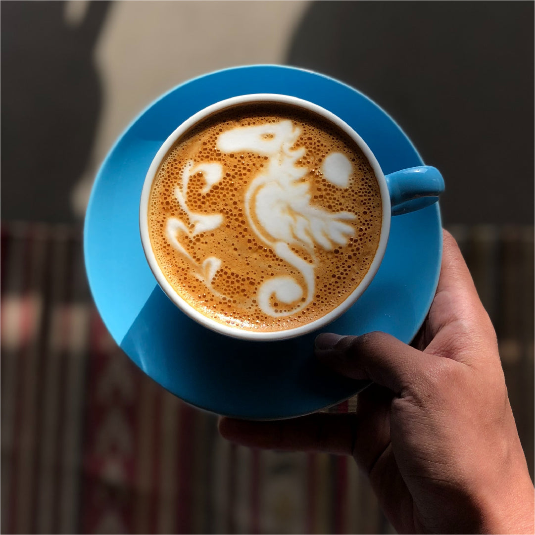 Latte art pouring in a ceramic cup
