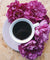 Cup of coffee surrounded by flowers