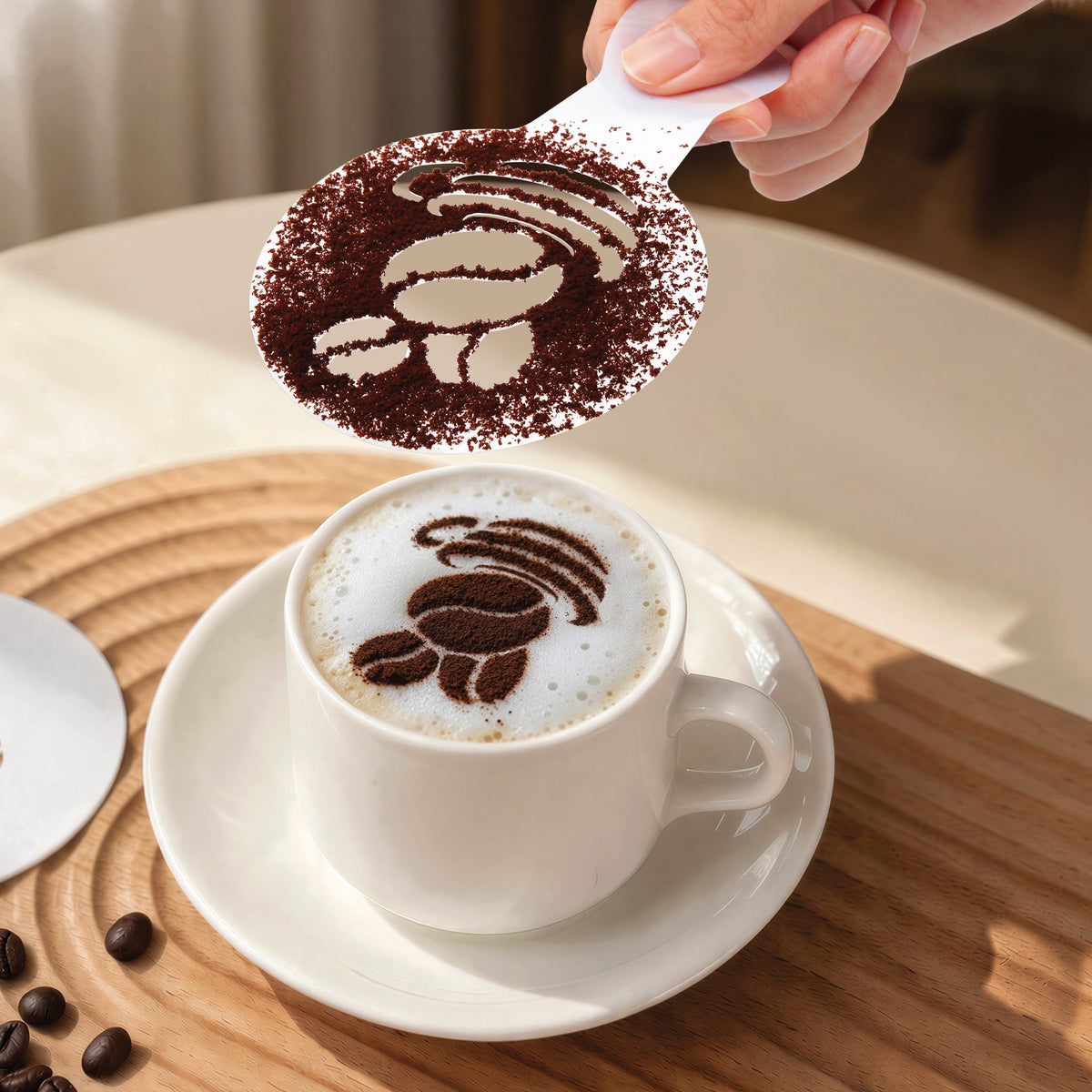 Dusting cocoa through a coffee bean stencil onto a cappuccino