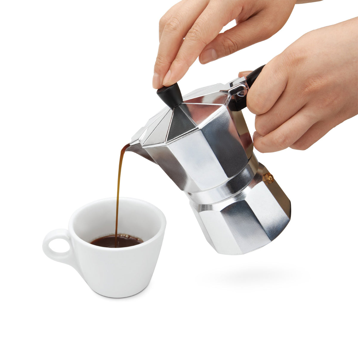 Pouring coffee from the 3-cup moka pot into a white cup