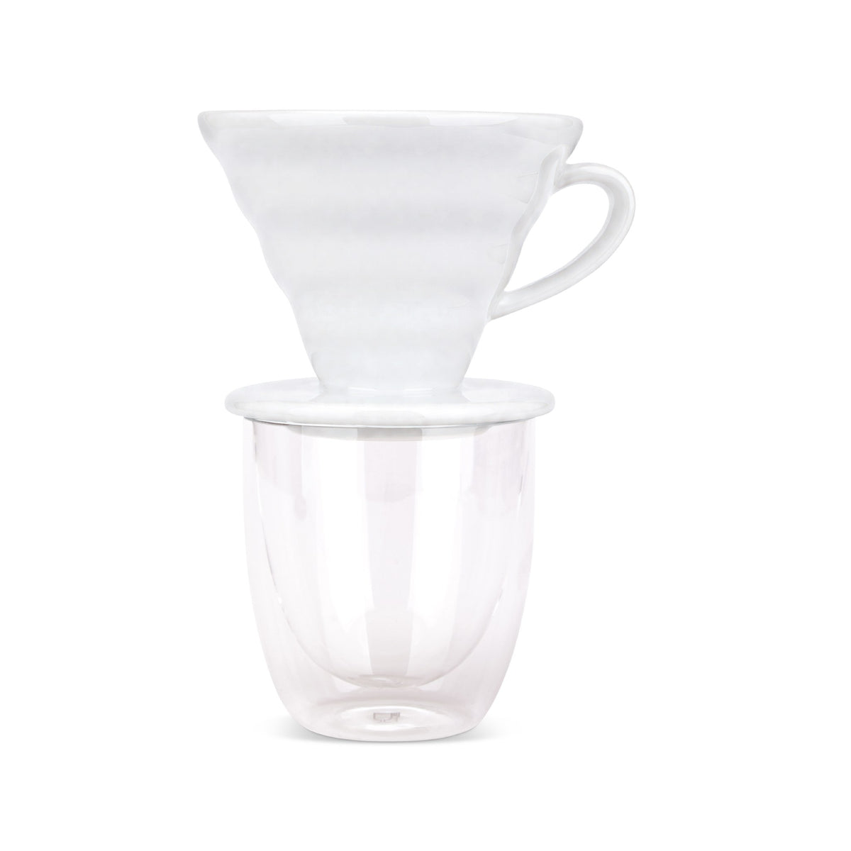 EspressoWorks white ceramic pour over coffee dripper sitting on a double-wall glass cup